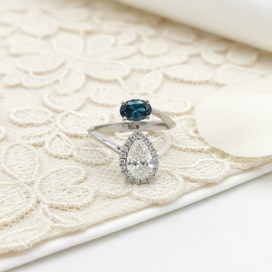 14K White Gold Ladies’ Ring Featuring 0.65ct Natural Blue Diamond and 1.17ct Pear-Cut White Diamond with Halo Accents